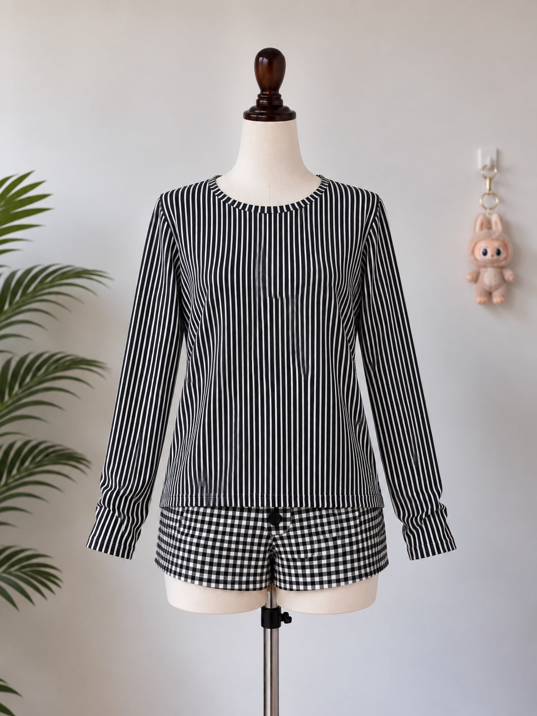 Black and white striped long sleeve top on mannequin