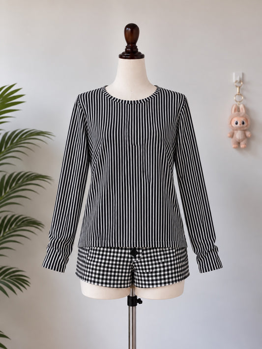 Black and white striped long sleeve top on mannequin