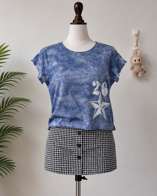 Blue tie-dye crop top with 26 star graphic on mannequin