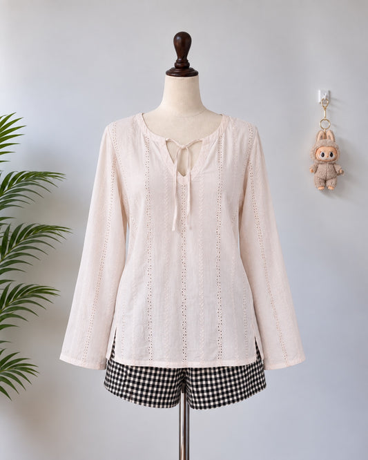 Cream embroidered long sleeve top on mannequin