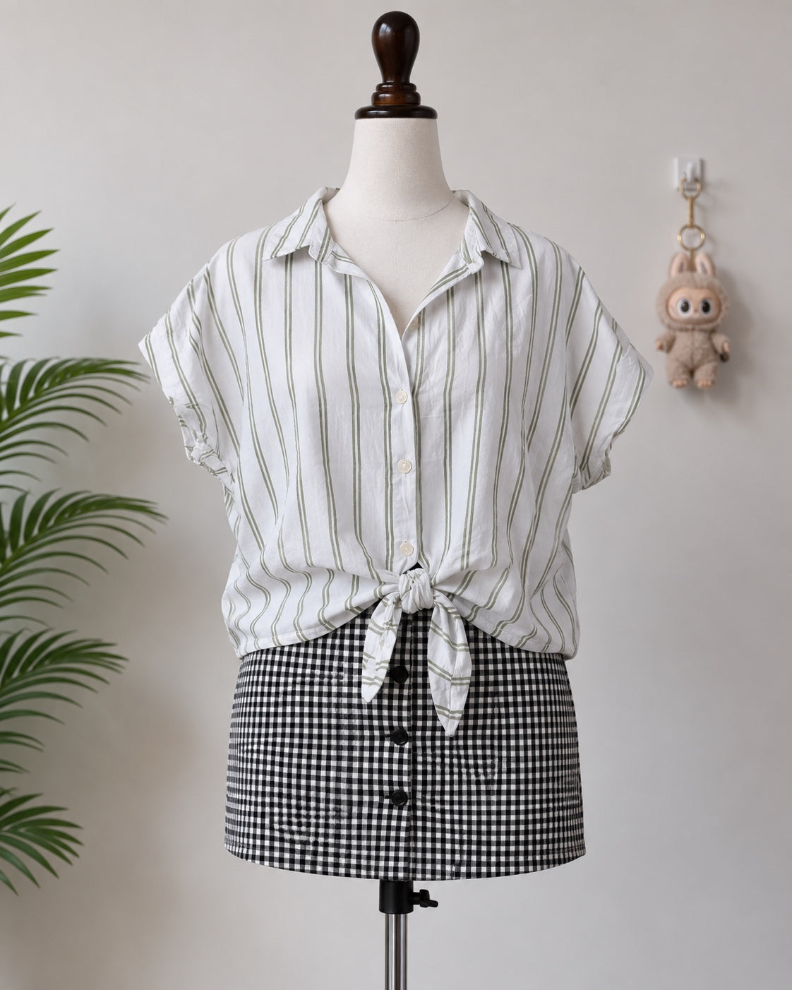 White and green striped short sleeve shirt on mannequin