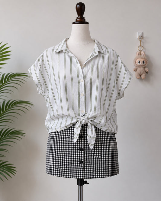 White and green striped short sleeve shirt on mannequin